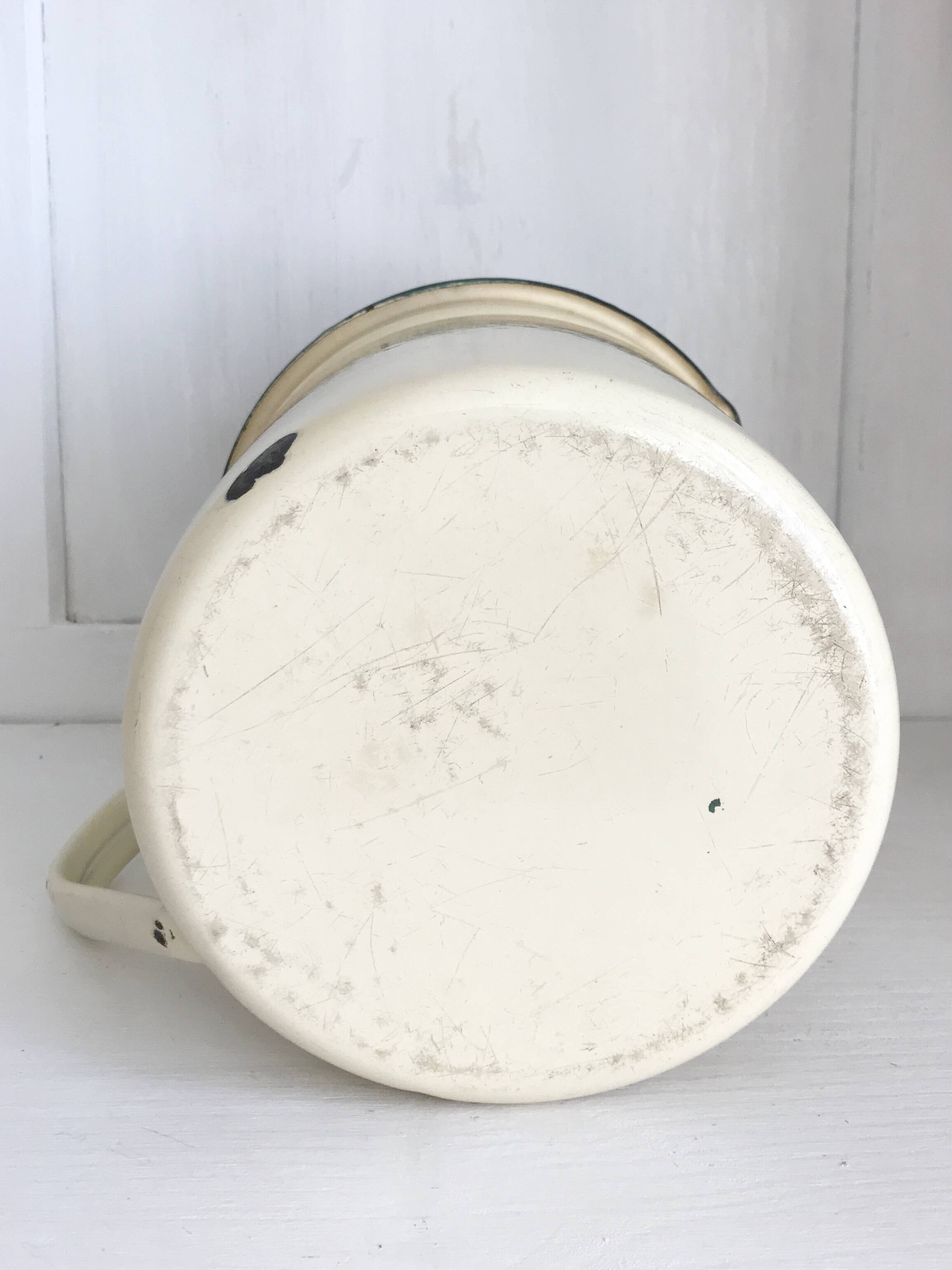 Old milk jug in enameled sheet metal