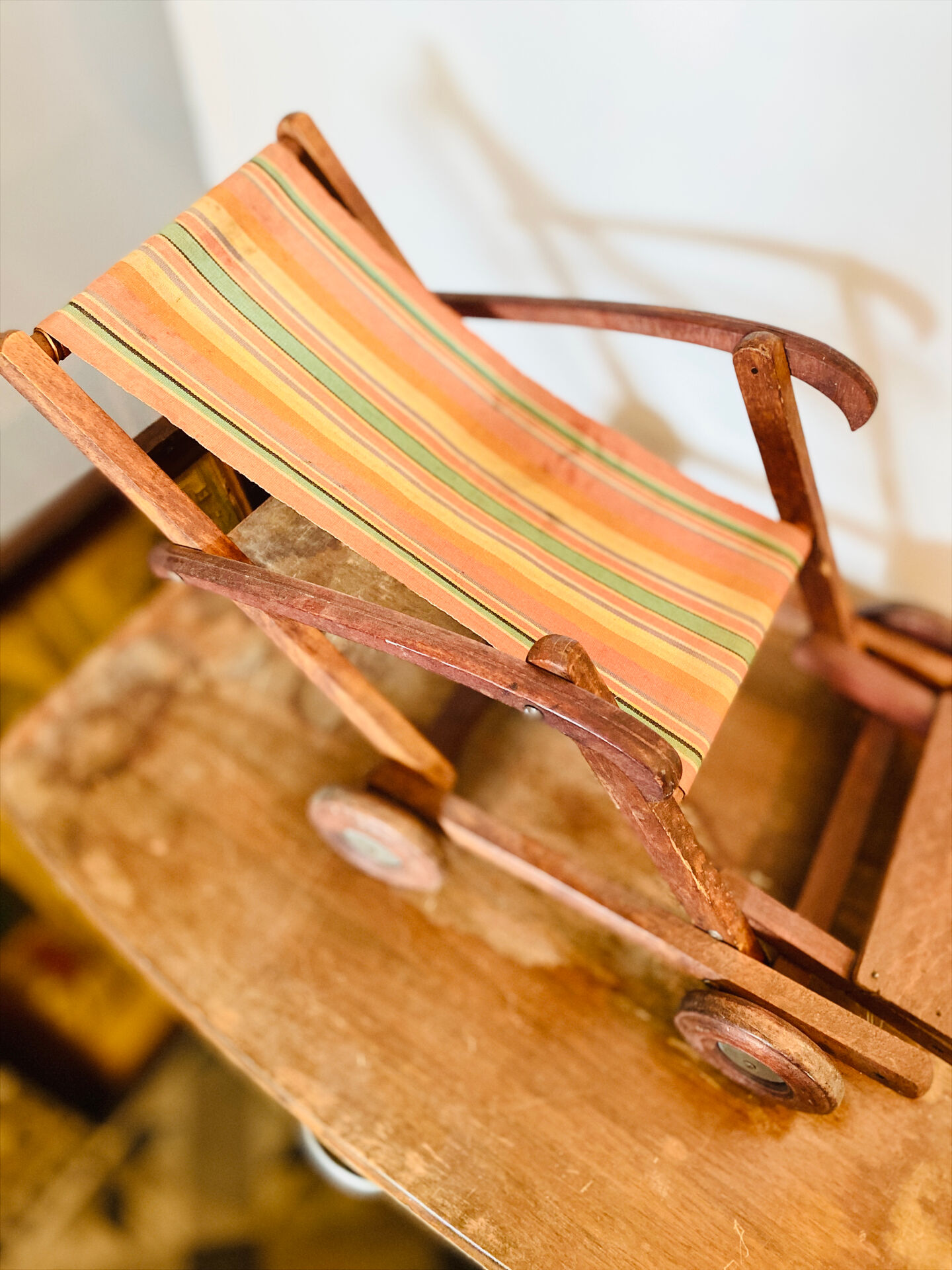 Vintage wooden folding doll's deckchair on wheels