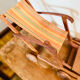 Vintage wooden folding doll's deckchair on wheels