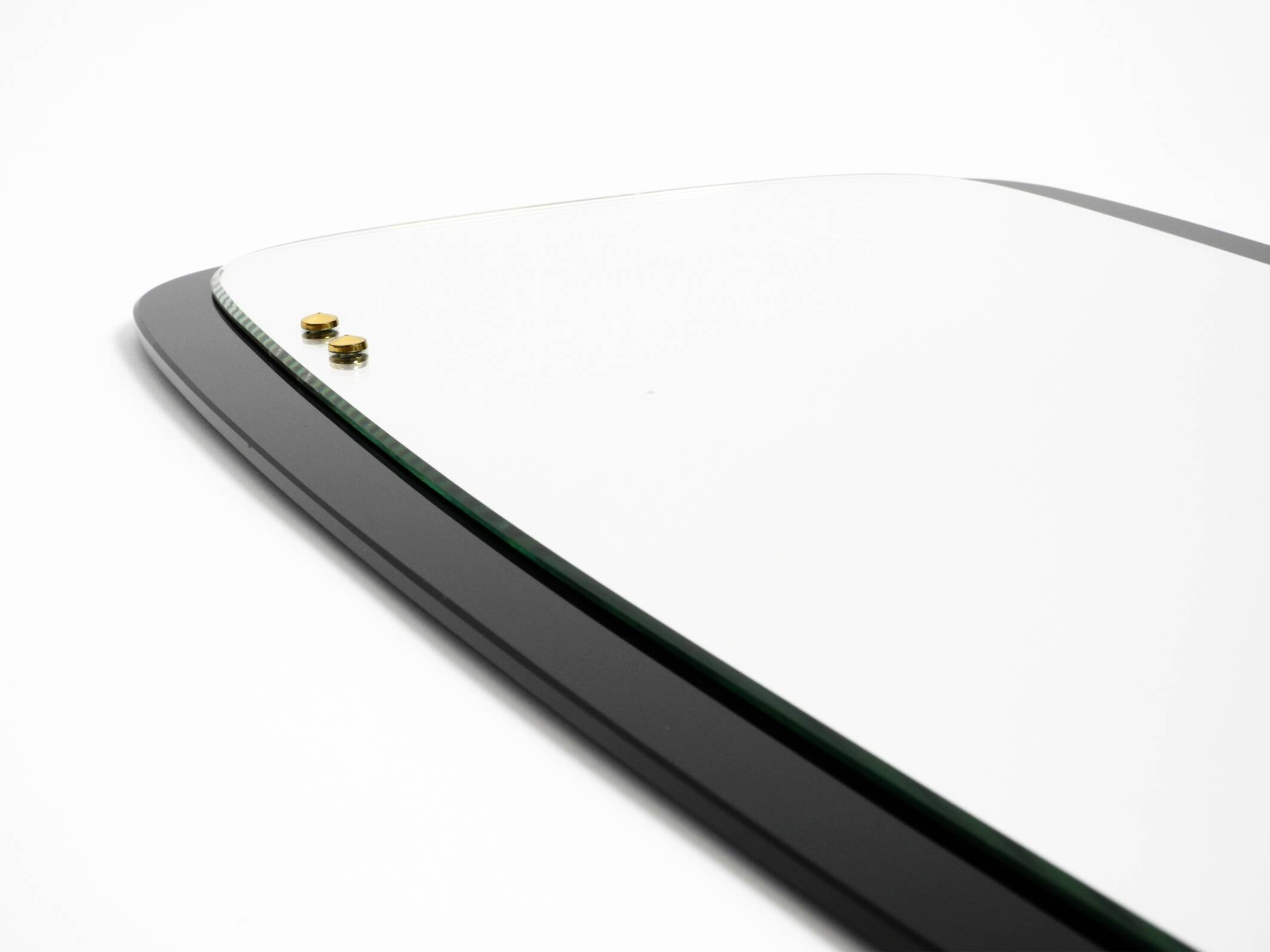 Large Mid Century wall mirror with extraordinary black glass frame