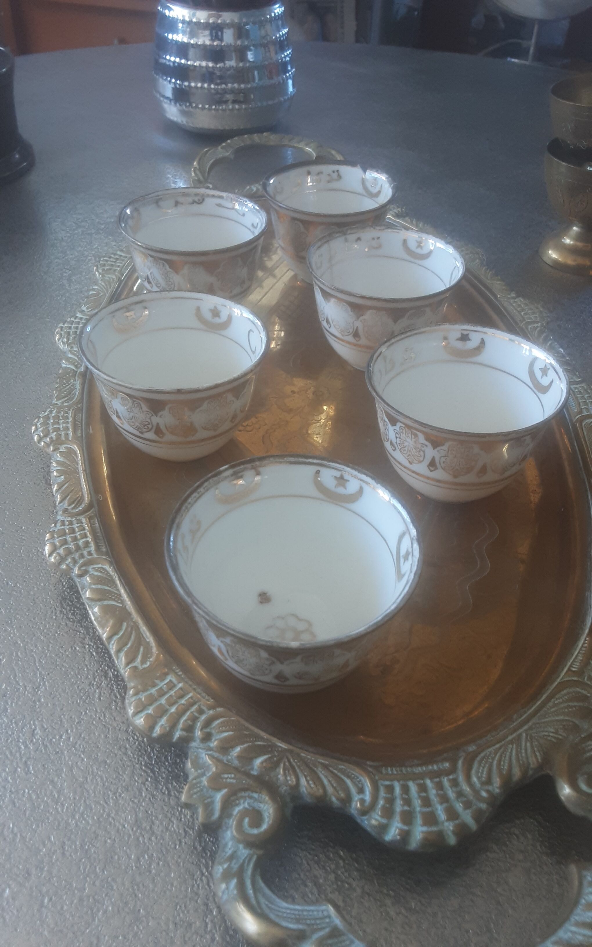 Old service porcelain brass cups