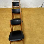 4 Scandinavian chairs in teak and black faux leather.