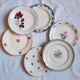 7 mismatched antique dessert plates accompanied by a pie dish