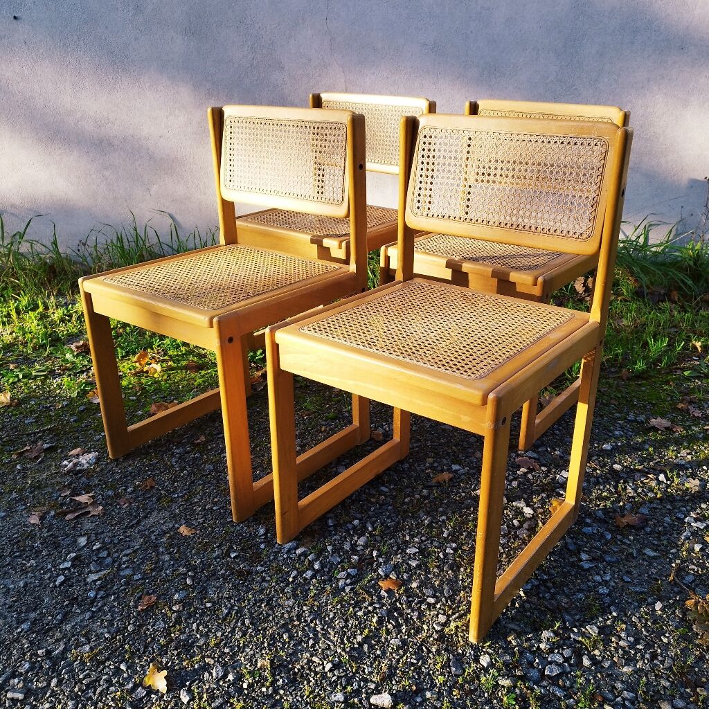 Four trendy tanned wooden chairs