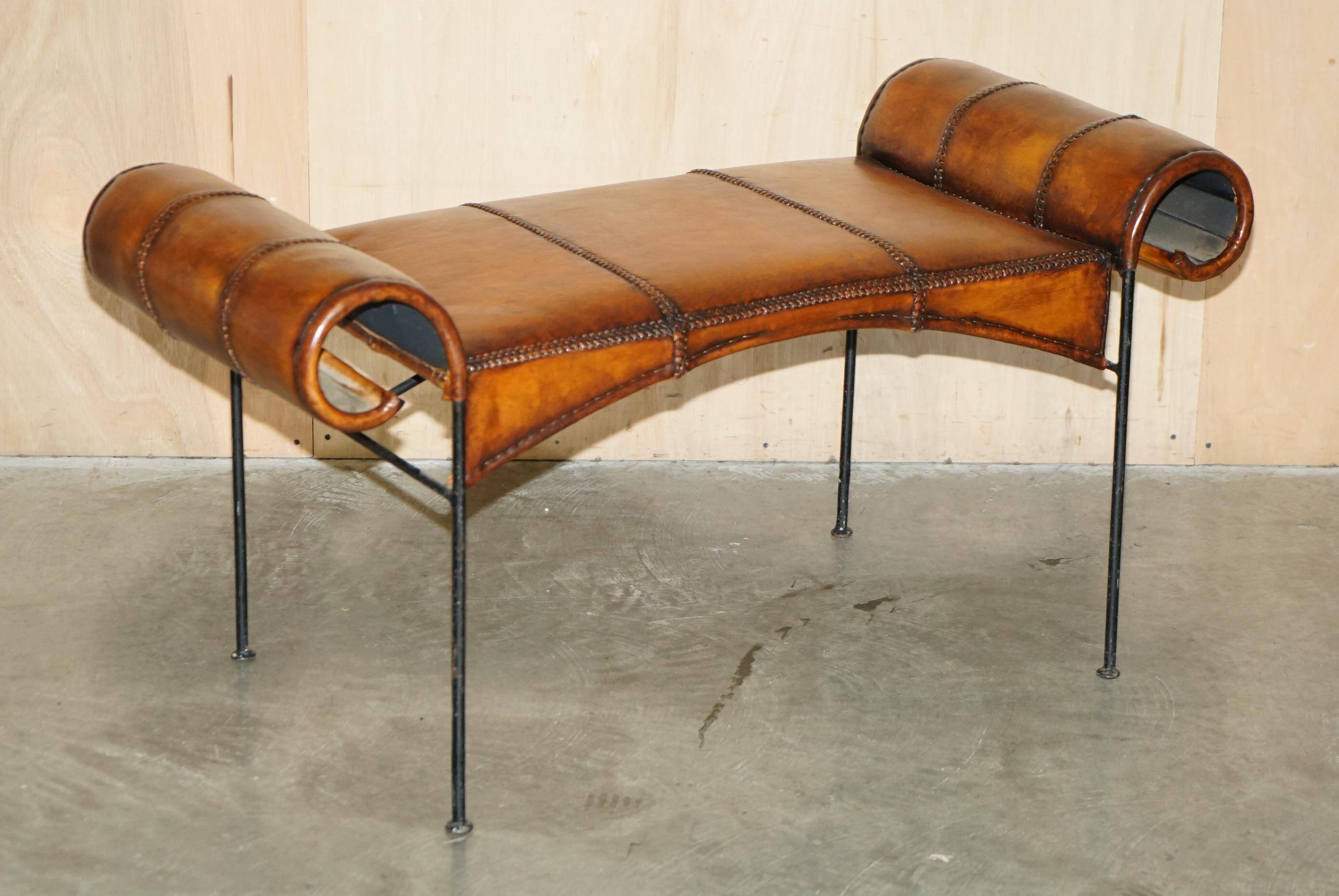 Vintage Spanish window bench in hand-stitched leather and restored iron.