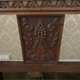 Antique armchair in carved wood with a straw seat.