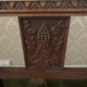 Antique armchair in carved wood with a straw seat.
