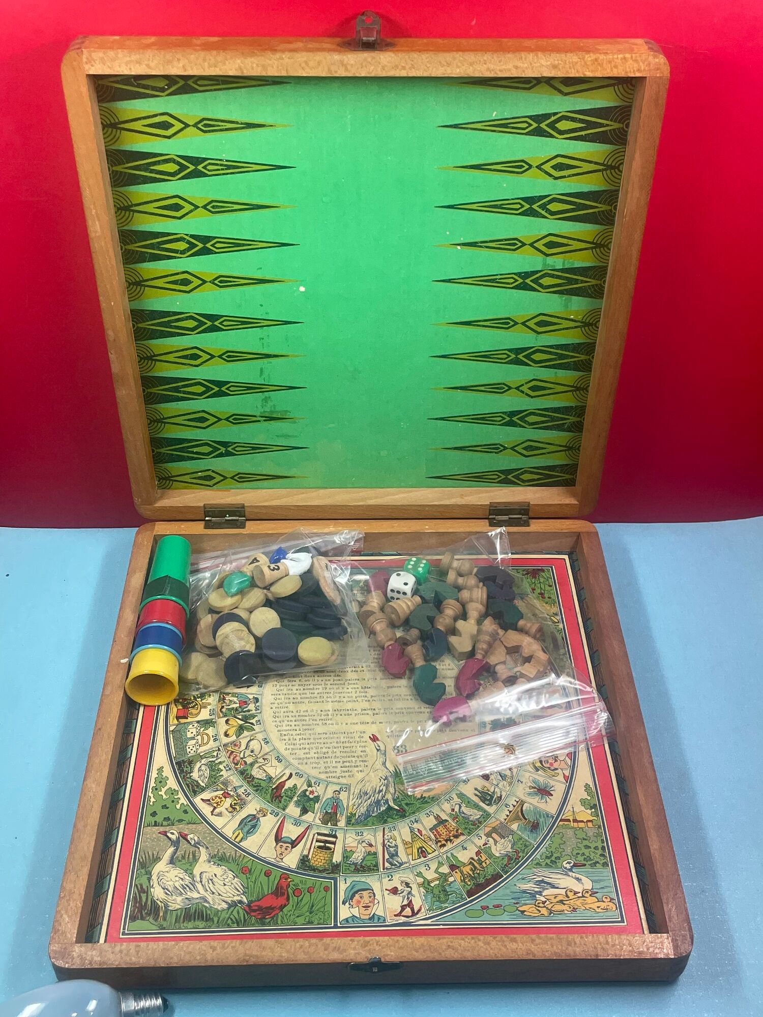 old wooden checkers' box, goose game, dada horses and jacquet with pawns. collectible game