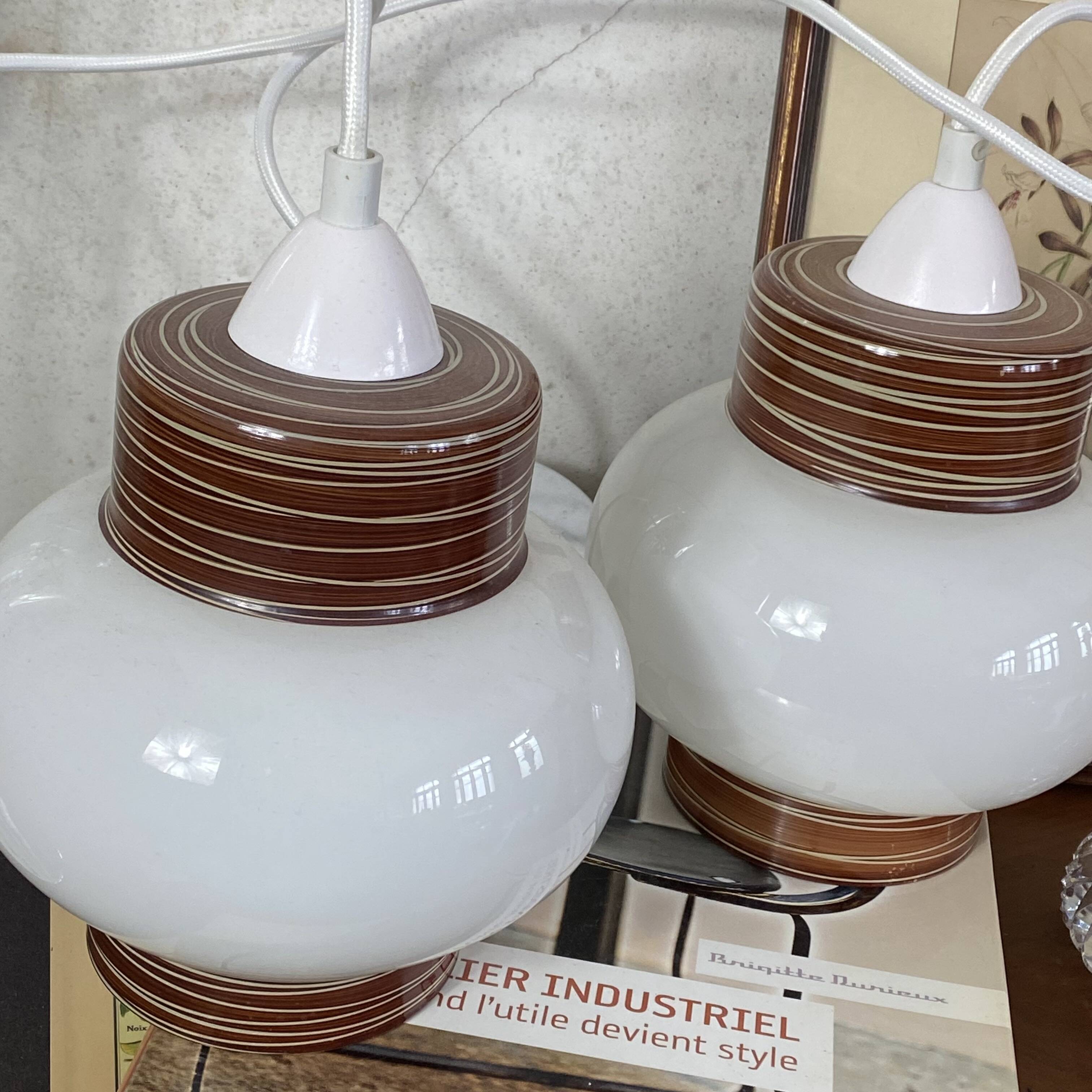 Pair of pendant lights with white glass shades from the 1950s.
