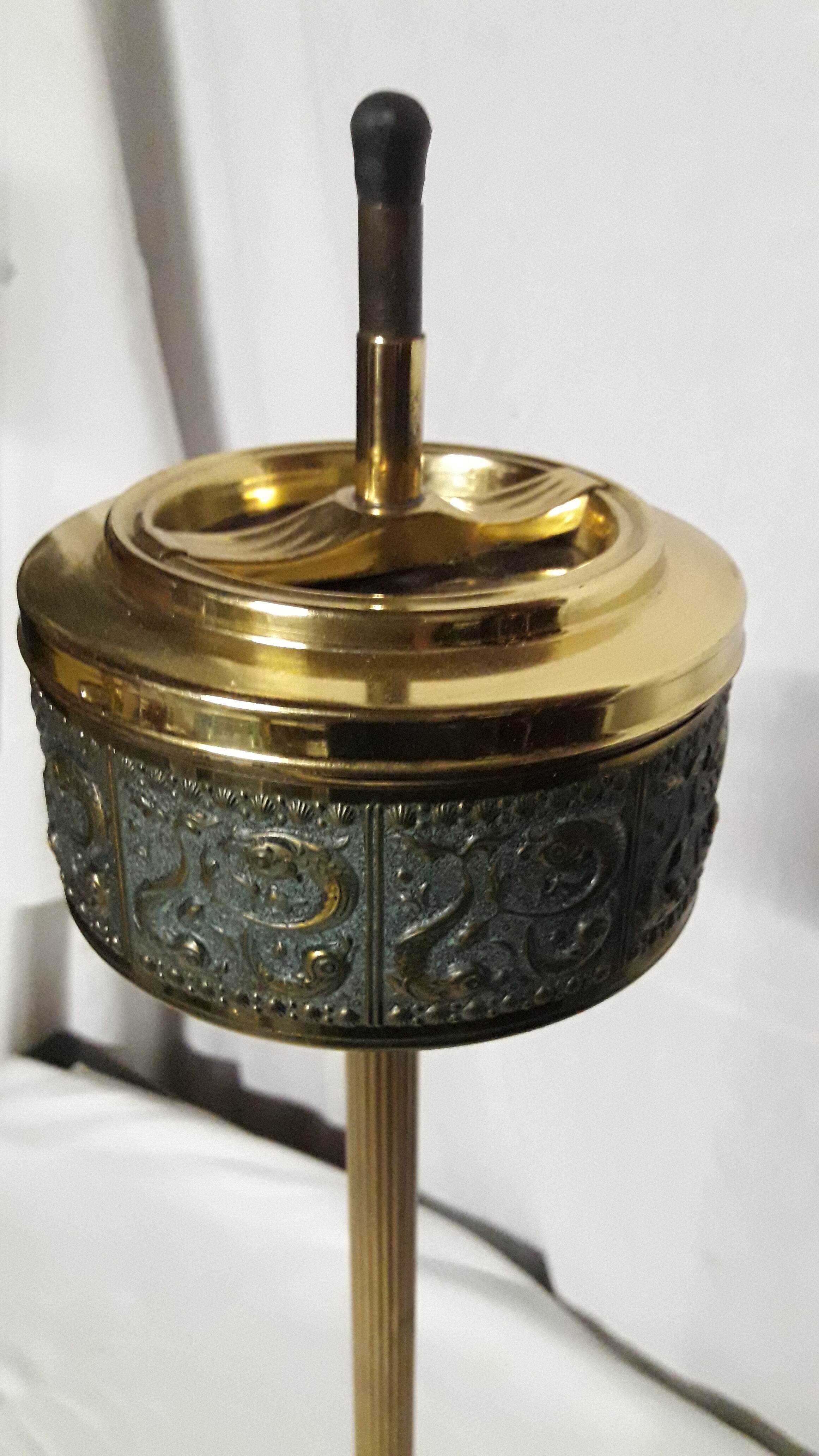 Gold metal standing ashtray and black marble base