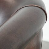 Dark brown vintage club armchair in English style made of sheepskin leather