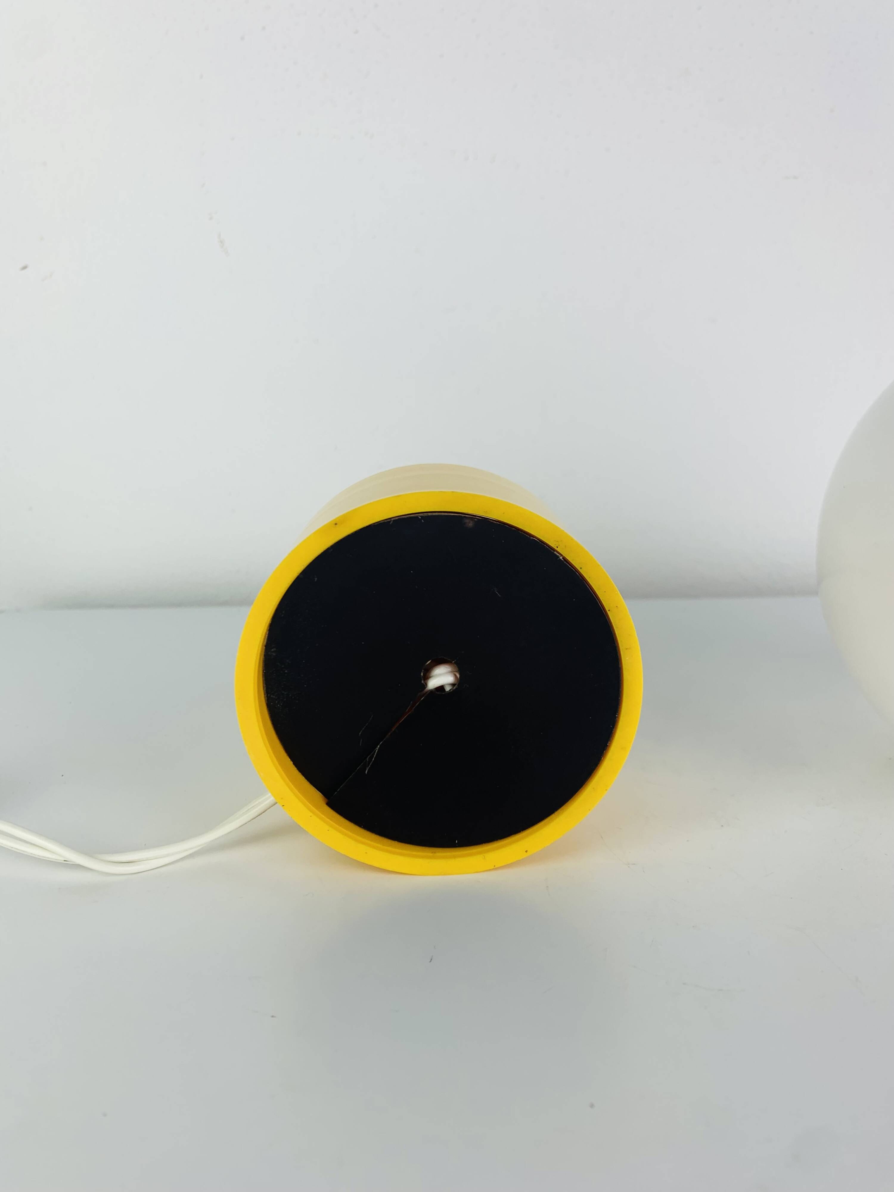 Space Age ball lamp, opaline with a yellow base, 1960s.