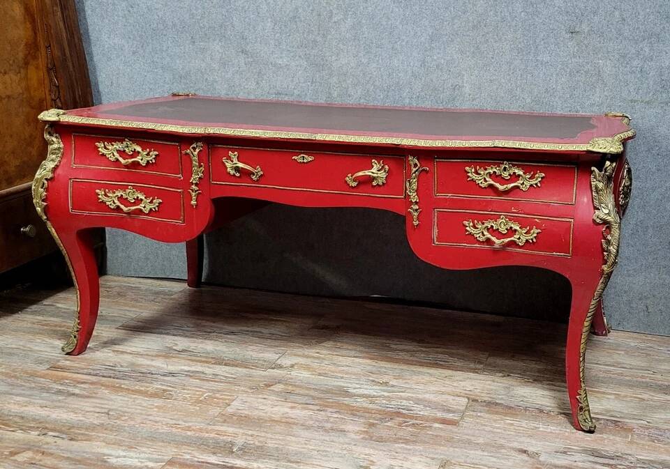 Louis XV style curved center desk in red lacquer and gilded bronze