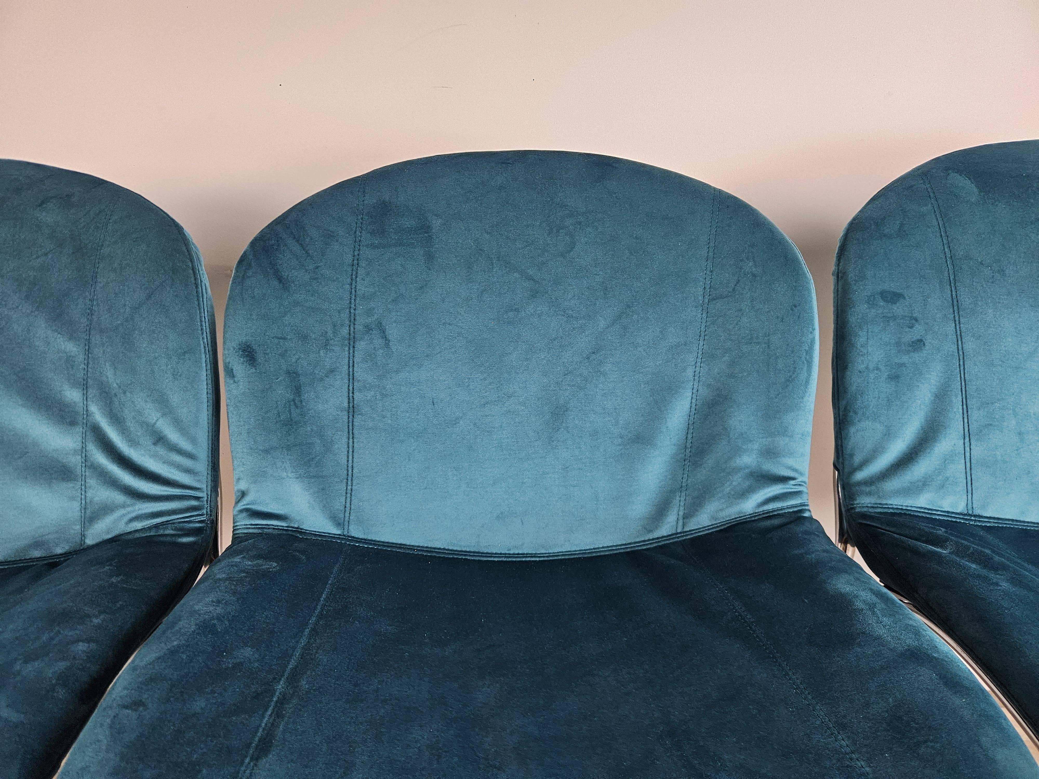 Four 1970s tubular chairs upholstered in blue velvet