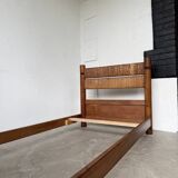 Brutalist style bed with chain and straw