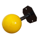Vintage yellow wooden wall-mounted ball coat hook.
