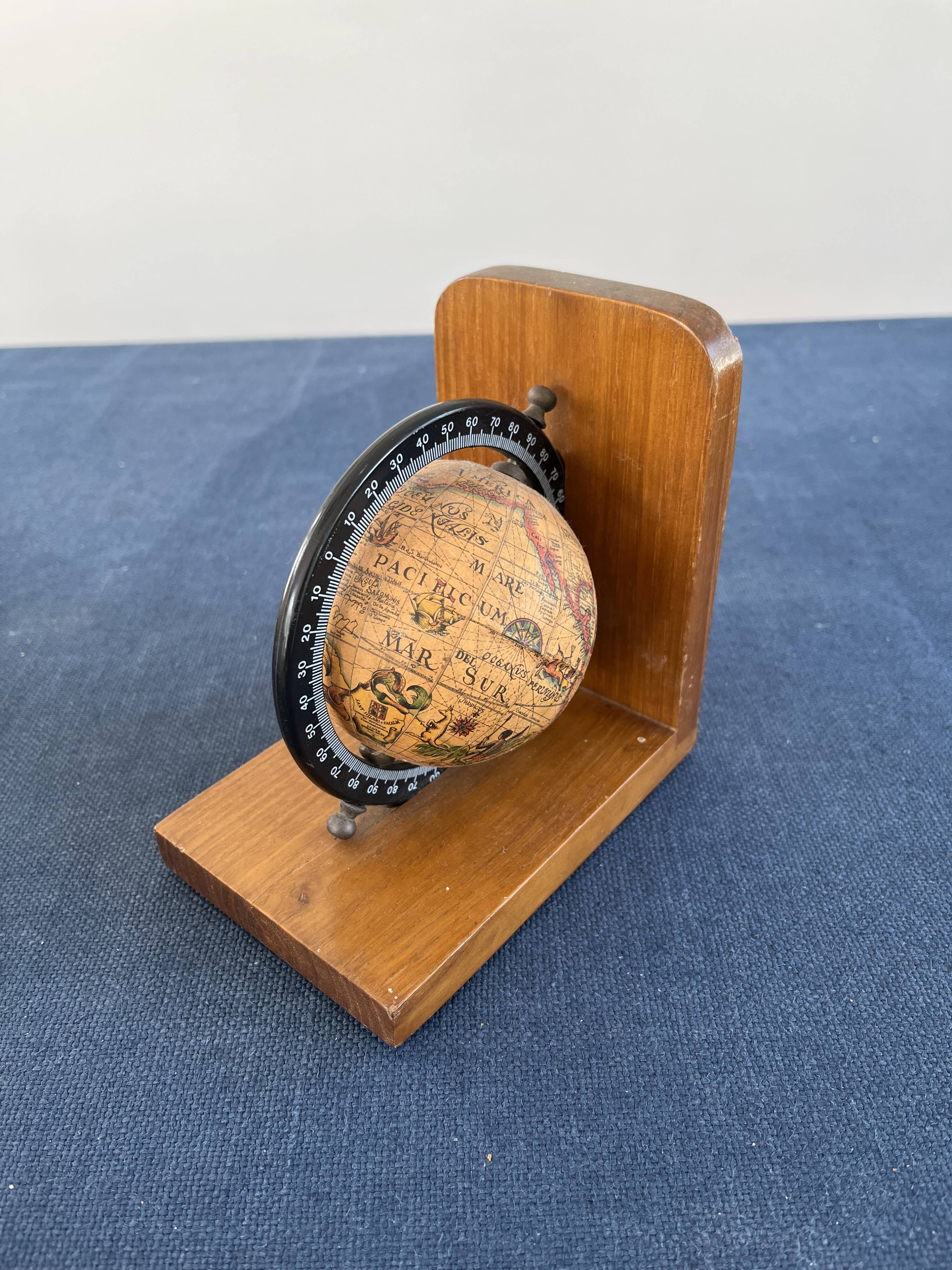 Rotating globe bookends on wooden base