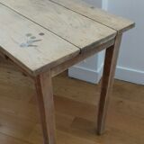 Small old wooden table with inclusion of coins and keys