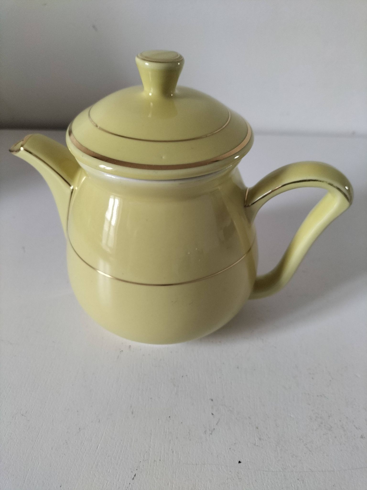 Vintage teapot in pastel yellow earthenware with gold trim