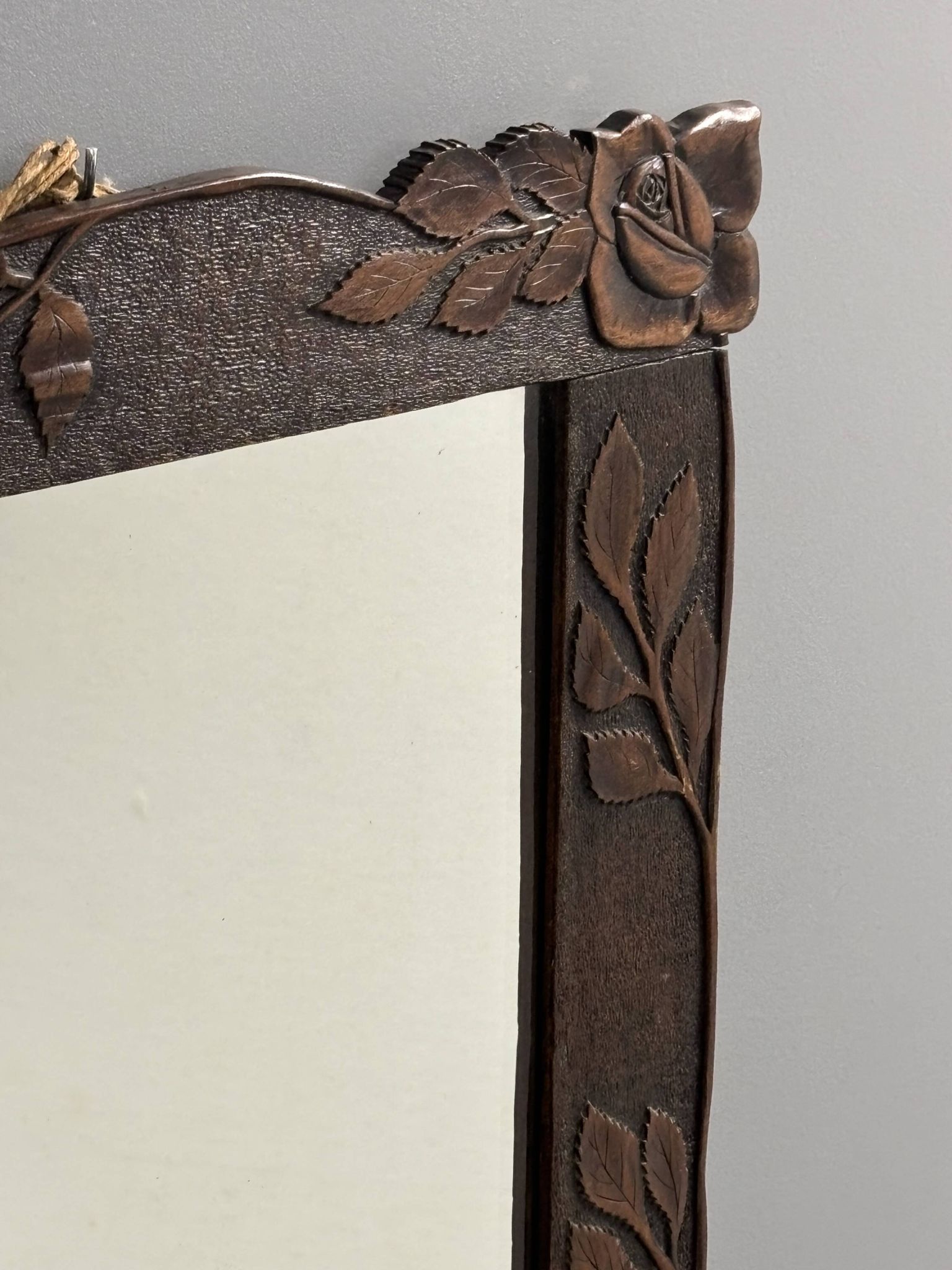 Arts & Crafts hand-carved wall mirror with floral roses, early 20th century