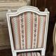 Pair of Louis XVI style chairs in painted wood and satin, classic elegance.