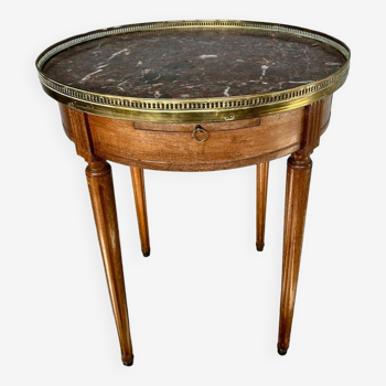 Hot water bottle table with a marble top and a brass gallery.