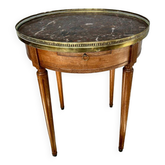 Hot water bottle table with a marble top and a brass gallery.