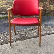 Red office chair in faux leather and wood, Mid-Century style (1960s)
