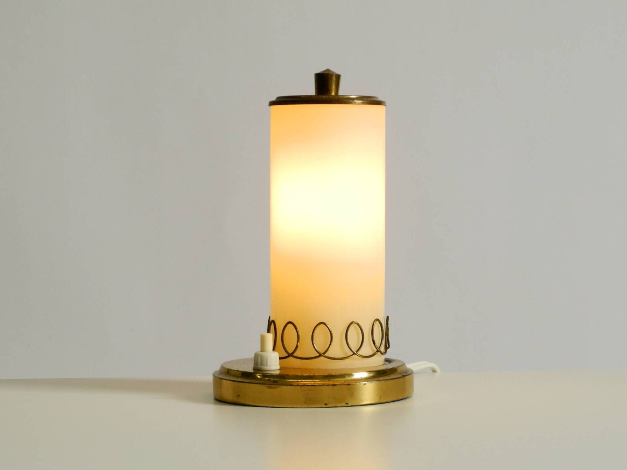A beautiful, rare 1950s brass table lamp with one opal glass shade adorned
