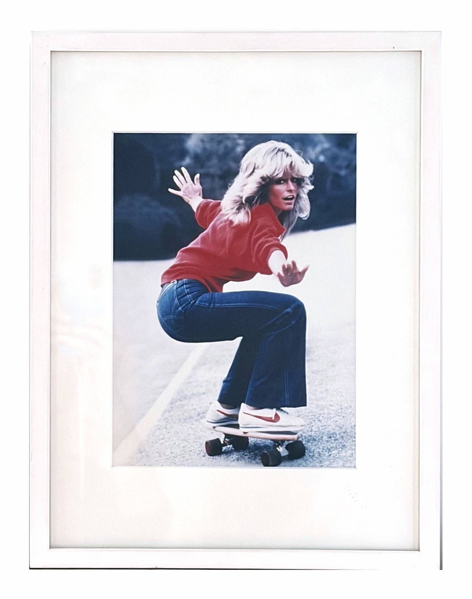 Framed photograph of Farrah Fawcett on a skateboard, 1976, digital print.