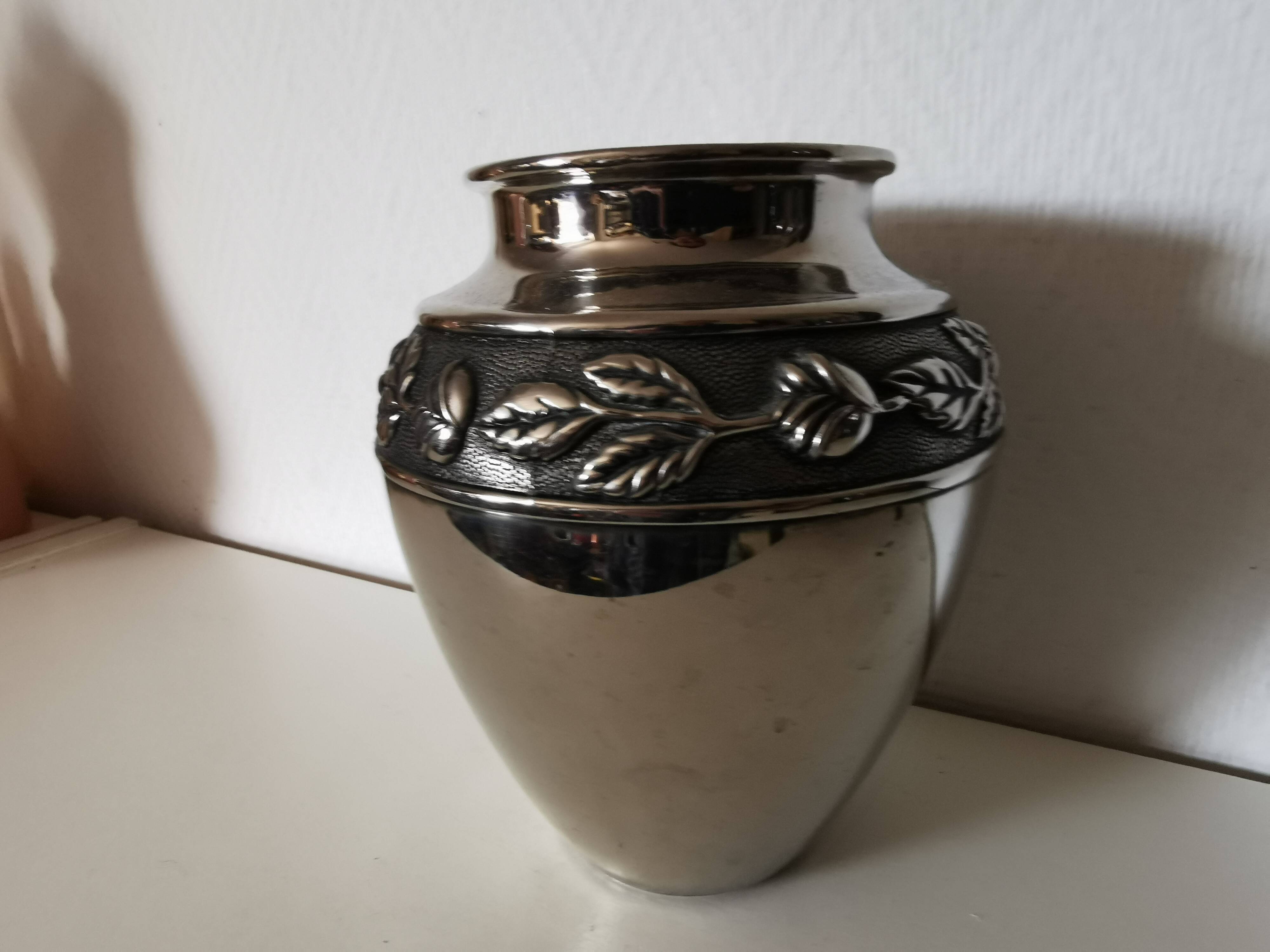 metal vase, flowers in relief