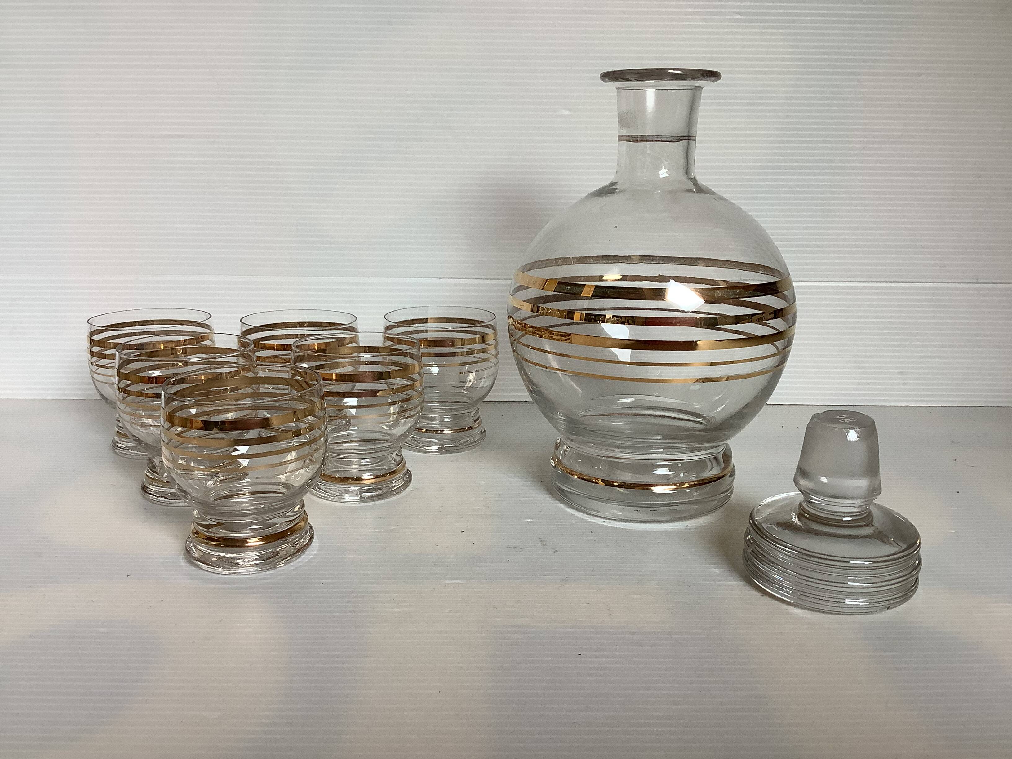 Antique liqueur set with a gold rim.