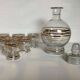 Antique liqueur set with a gold rim.