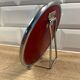 Small round barber-style mirror.