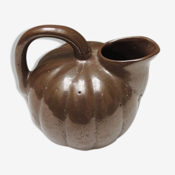 Old pitcher in glazed brown ceramic