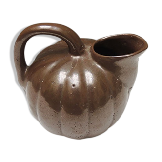 Old pitcher in glazed brown ceramic