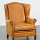 Cow leather wingback chair finished with decorative nails