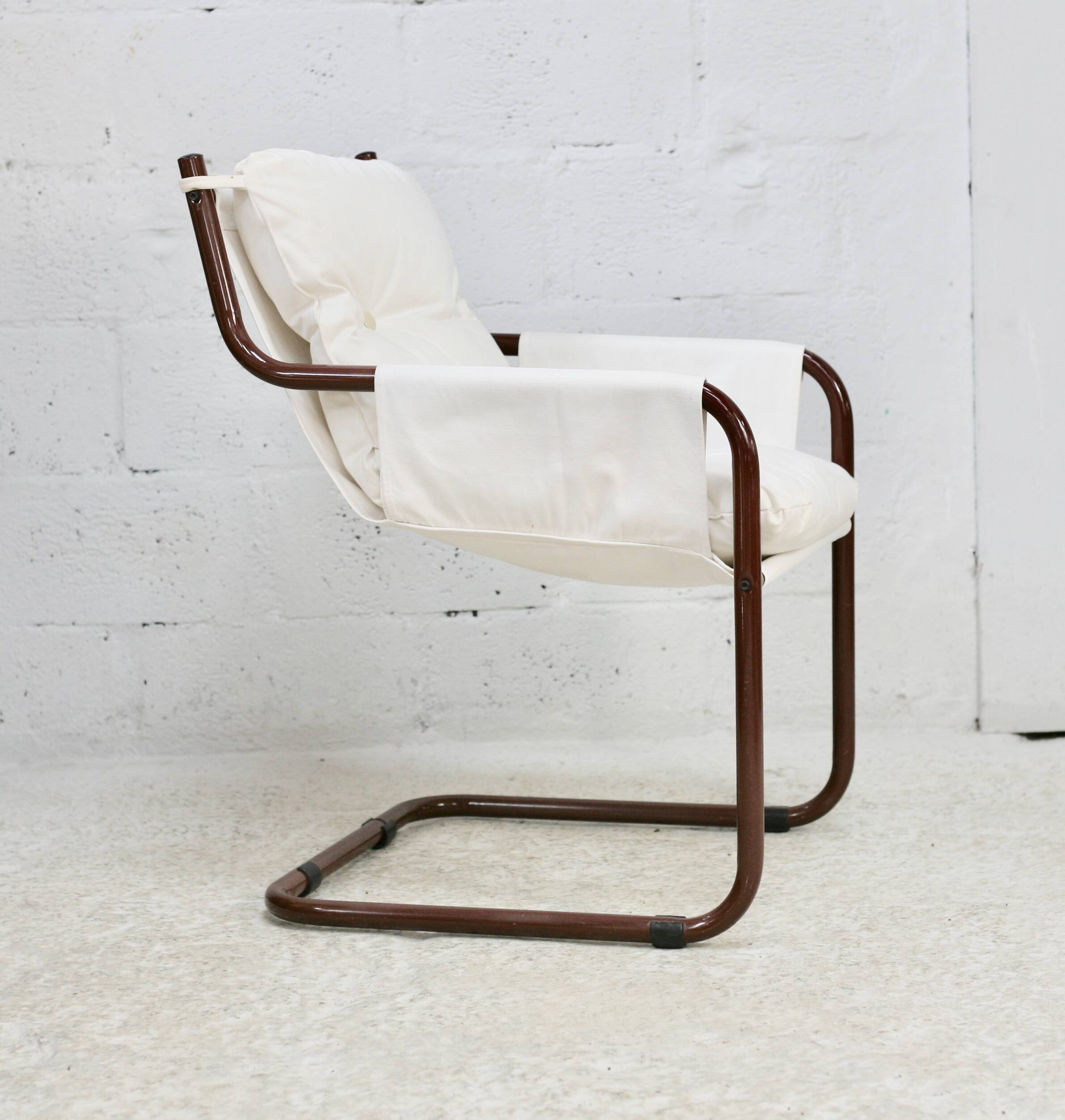 Tubular armchair, fabric suspended seat. Circa 1970