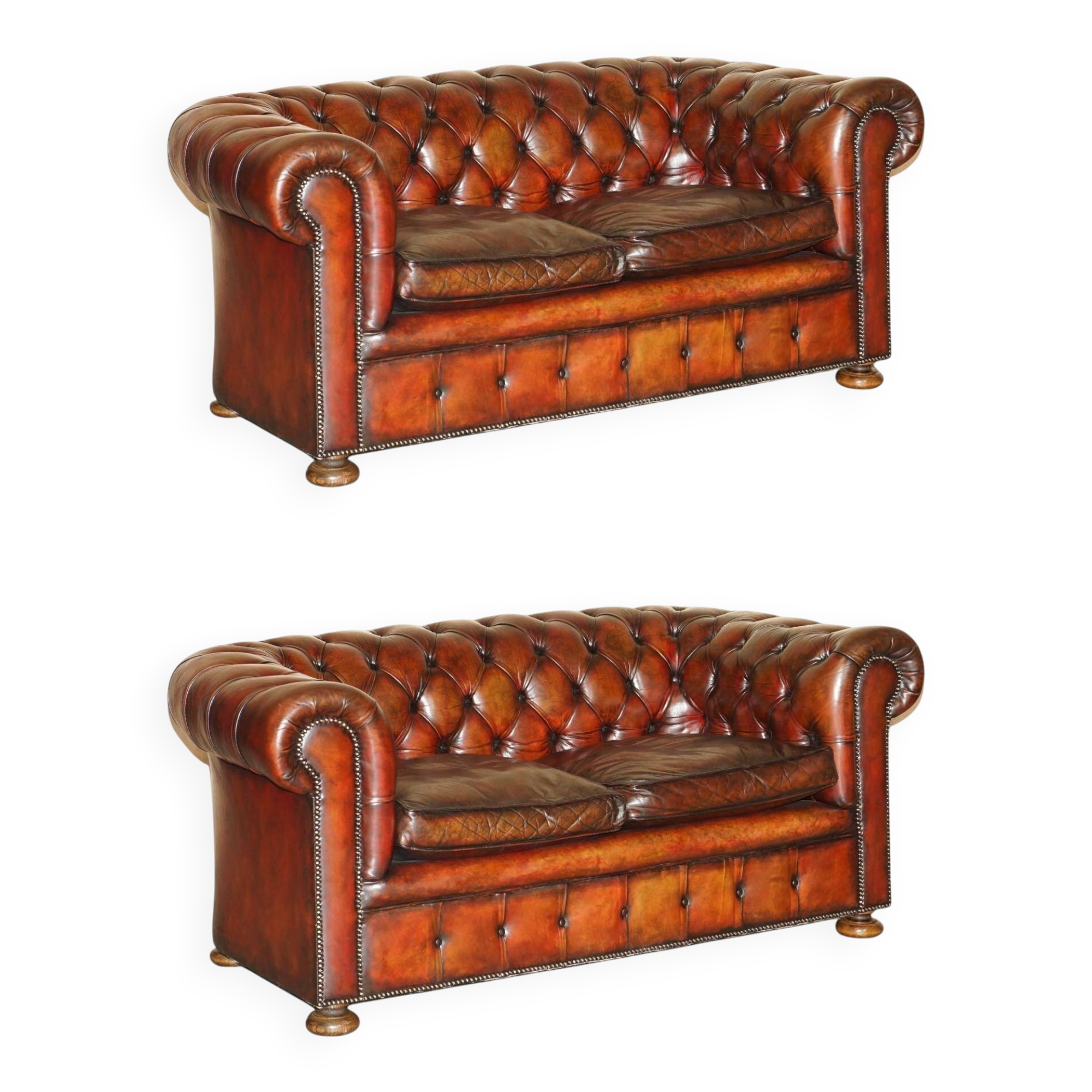 Pair of restored antique Chesterfield sofas in Boudreaux leather.
