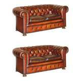 Pair of restored antique Chesterfield sofas in Boudreaux leather.