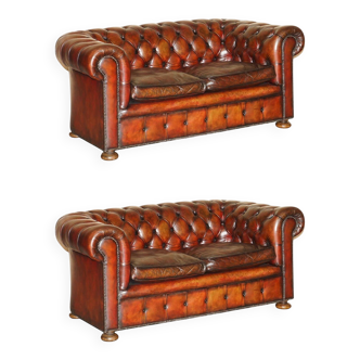 Pair of restored antique Chesterfield sofas in Boudreaux leather.