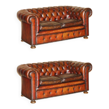 Pair of restored antique Chesterfield sofas in Boudreaux leather.