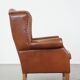 Cognac-colored leather wingback chair in English style