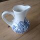 Small old pitcher in iron earth