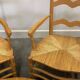 Pair of French Provencal Radassier beech chairs and ottoman, with rush seating.
