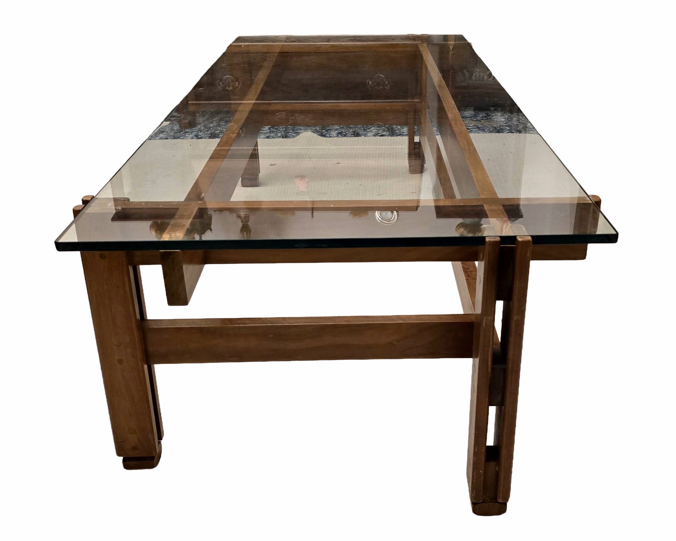 Glass coffee table with a wooden frame.