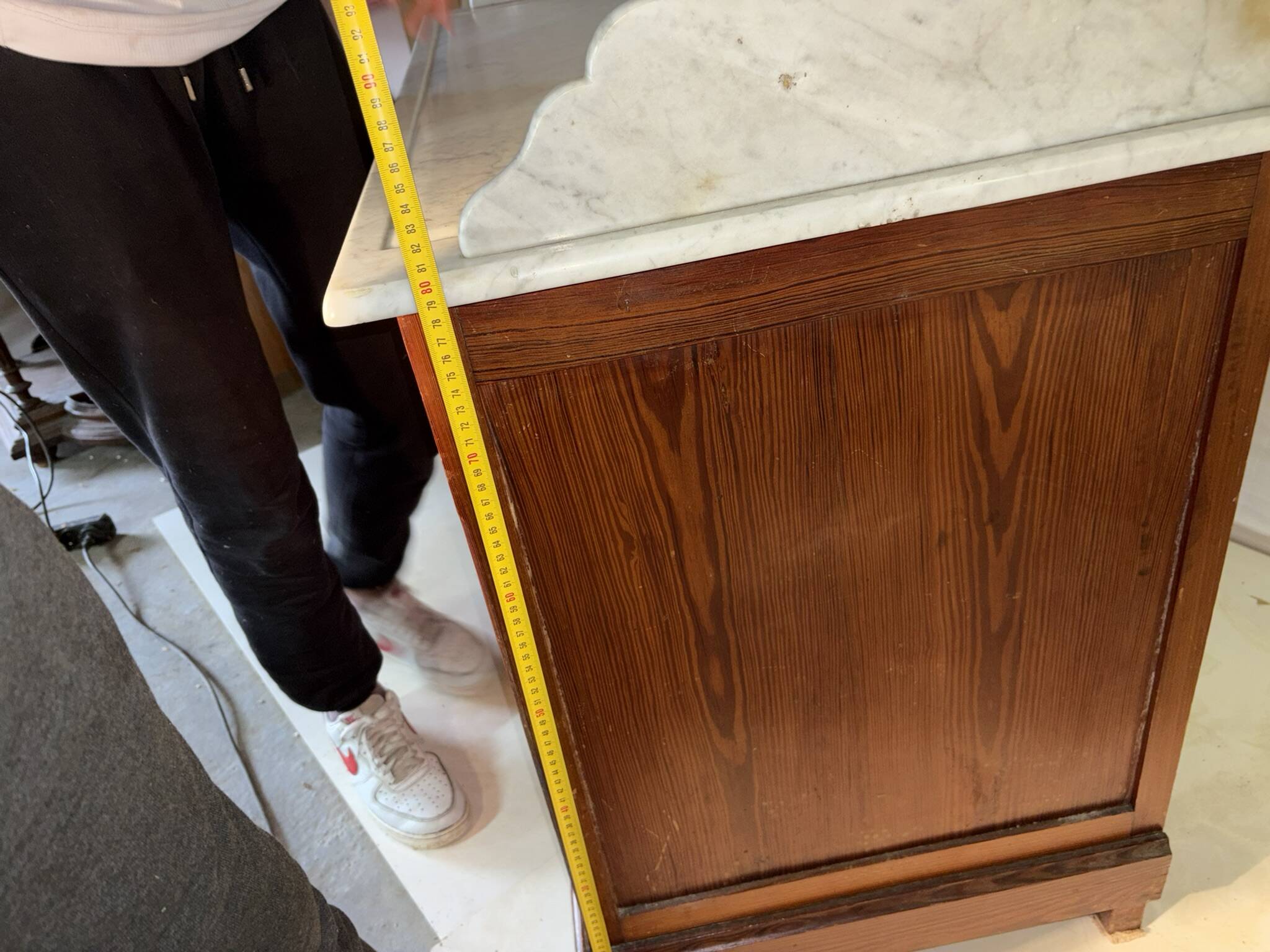 Antique wood and marble kitchen sideboard with carved backsplash