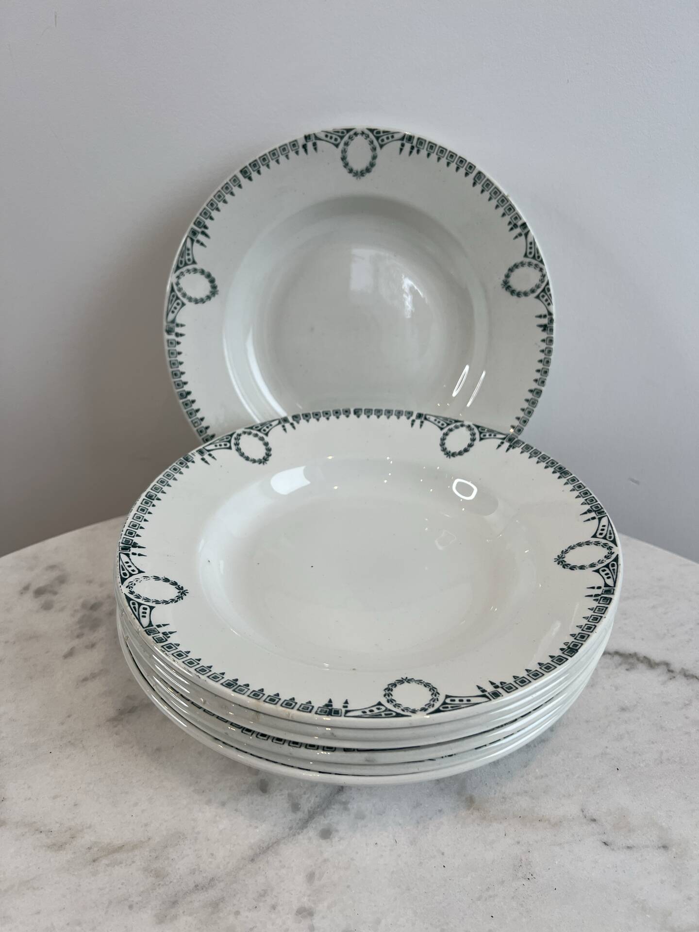Set of 7 deep plates in earthenware, decorated with a green frieze.