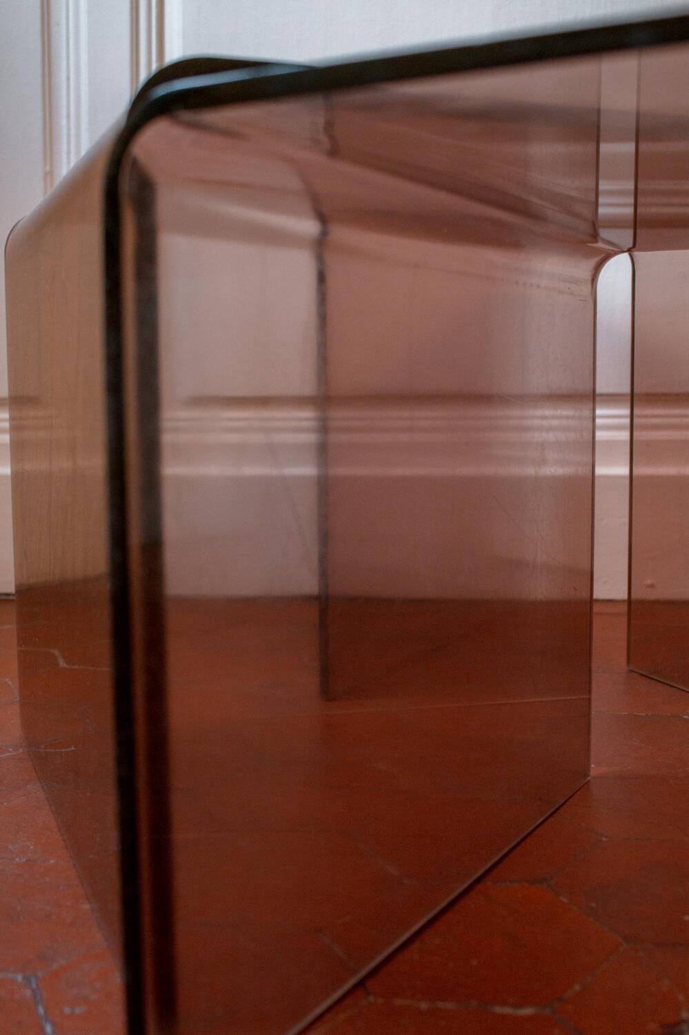 Vintage trio of nesting tables in smoked plexiglass by Michel Dumas, year.