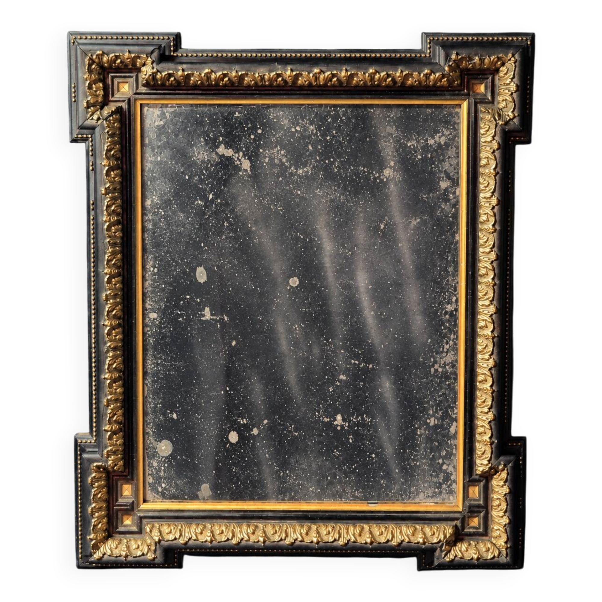Napoleon III mirror in blackened wood and gilded decoration, second half of the 19th century.